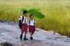 2707755-R3L8T8D-650-two-kids-under-a-banana-leaf-in-the-rain.jpg